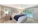 Bedroom with king bed, pool access, and ceiling fan at 605 Wild Turkey Ln, Sarasota, FL 34236