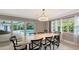 Dining room with marble table, pool view, and natural light at 605 Wild Turkey Ln, Sarasota, FL 34236