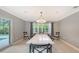 Bright dining room with marble table and large windows at 605 Wild Turkey Ln, Sarasota, FL 34236
