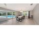 Elegant dining room with marble table and pool access at 605 Wild Turkey Ln, Sarasota, FL 34236