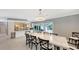 Open concept dining room with marble table and pool view at 605 Wild Turkey Ln, Sarasota, FL 34236
