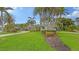 Large home with lush tropical landscaping and a circular driveway at 605 Wild Turkey Ln, Sarasota, FL 34236