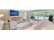 Bright living room with pool view, comfortable seating, and large TV at 605 Wild Turkey Ln, Sarasota, FL 34236