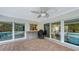 Brick paved patio with sliding glass doors, pool view, and outdoor grill at 605 Wild Turkey Ln, Sarasota, FL 34236