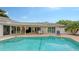 Inviting pool area with covered lanai and comfortable lounge chair at 605 Wild Turkey Ln, Sarasota, FL 34236