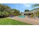 Refreshing pool area with lounge chairs, lush landscaping, and green lawn at 605 Wild Turkey Ln, Sarasota, FL 34236