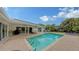 Relaxing pool area with patio furniture, covered lanai, and brick pavers at 605 Wild Turkey Ln, Sarasota, FL 34236