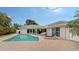 Serene pool and patio area with lounge chair and covered lanai at 605 Wild Turkey Ln, Sarasota, FL 34236