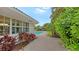 Brick walkway leading to the pool with lush landscaping at 605 Wild Turkey Ln, Sarasota, FL 34236