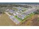 Aerial view of a residential neighborhood with houses and a pond at 6609 114Th E Ave, Parrish, FL 34219