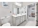 Modern bathroom with dual sinks and a large mirror at 6609 114Th E Ave, Parrish, FL 34219