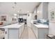 Modern kitchen with white cabinets, stainless steel appliances, and an island at 6609 114Th E Ave, Parrish, FL 34219