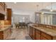 Open concept kitchen with stainless appliances and bar overlooking dining and living area at 6630 Horned Owl Pl, Sarasota, FL 34241