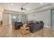 Spacious living room with tile flooring, comfortable seating, and a view of the outdoors at 6630 Horned Owl Pl, Sarasota, FL 34241