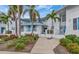 Condo building exterior, featuring a walkway and tropical landscaping at 829 Audubon Dr # 829, Bradenton, FL 34209