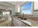 Kitchen features granite countertops, a double sink, and a view into dining area at 829 Audubon Dr # 829, Bradenton, FL 34209