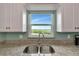 Kitchen sink with granite countertop and water view from window at 829 Audubon Dr # 829, Bradenton, FL 34209
