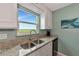 Kitchen features granite countertops, a double sink, and a view overlooking the water at 829 Audubon Dr # 829, Bradenton, FL 34209
