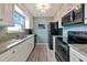 Modern kitchen with granite counters, stainless steel appliances, and light wood flooring at 829 Audubon Dr # 829, Bradenton, FL 34209