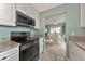 Kitchen with black appliances and view into dining area at 829 Audubon Dr # 829, Bradenton, FL 34209