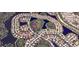 An aerial view showcasing a residential area with houses near a body of water at 8303 Deerbrook Cir, Sarasota, FL 34238