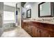 Bathroom boasts double vanity, granite countertop, and large mirror at 8303 Deerbrook Cir, Sarasota, FL 34238