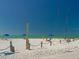 Relaxing beach scene with sailboats and beach umbrellas at 8303 Deerbrook Cir, Sarasota, FL 34238
