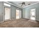 Primary bedroom with carpet, ceiling fan, and access to bathroom and other rooms at 8303 Deerbrook Cir, Sarasota, FL 34238
