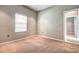 Simple bedroom with neutral walls and carpet at 8303 Deerbrook Cir, Sarasota, FL 34238