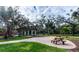 Relaxing community area with picnic tables and lush landscaping at 8303 Deerbrook Cir, Sarasota, FL 34238
