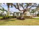 Beautiful home with lush landscaping and large tree at 8303 Deerbrook Cir, Sarasota, FL 34238