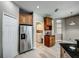 Kitchen features stainless steel refrigerator and laundry access at 8303 Deerbrook Cir, Sarasota, FL 34238