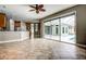 Open kitchen with breakfast bar, stainless steel appliances, and pool access at 8303 Deerbrook Cir, Sarasota, FL 34238