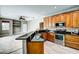 Kitchen boasts wood cabinets, granite counters, and stainless steel appliances at 8303 Deerbrook Cir, Sarasota, FL 34238