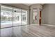 Bright living room with sliding glass doors leading to the pool and patio areas at 8303 Deerbrook Cir, Sarasota, FL 34238