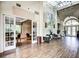 Spacious lobby with hardwood floors and large windows at 8303 Deerbrook Cir, Sarasota, FL 34238