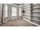 Home office with built-in shelving and carpet at 8303 Deerbrook Cir, Sarasota, FL 34238