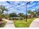 Landscaped tennis court with pathway access at 8303 Deerbrook Cir, Sarasota, FL 34238