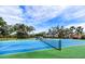 Two well-maintained tennis courts with blue surface and green perimeter at 8303 Deerbrook Cir, Sarasota, FL 34238