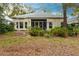 Home's back with screened porch and lush landscaping at 96 Tall Trees Ct, Sarasota, FL 34232