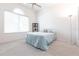 Bright bedroom with carpeted floor, featuring a queen bed and large window at 96 Tall Trees Ct, Sarasota, FL 34232