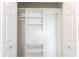 Spacious walk-in closet with built-in shelves and rods at 96 Tall Trees Ct, Sarasota, FL 34232