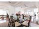 Open dining room with glass table and hardwood floors at 96 Tall Trees Ct, Sarasota, FL 34232