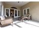 Bright enclosed patio furnished with comfortable seating at 96 Tall Trees Ct, Sarasota, FL 34232