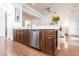 Kitchen island with stainless steel dishwasher and wood cabinets at 96 Tall Trees Ct, Sarasota, FL 34232