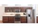 Kitchen with stainless steel appliances and dark wood cabinets at 96 Tall Trees Ct, Sarasota, FL 34232