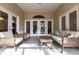 Relaxing lanai with wicker furniture and access to backyard at 96 Tall Trees Ct, Sarasota, FL 34232