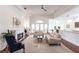 Open living room with hardwood floors, couches, and access to patio at 96 Tall Trees Ct, Sarasota, FL 34232