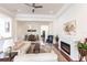 Open living space with hardwood floors, white walls, and a fireplace at 96 Tall Trees Ct, Sarasota, FL 34232