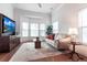 Bright living room with hardwood floors, comfy seating, and large windows at 96 Tall Trees Ct, Sarasota, FL 34232